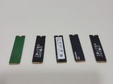 a close up of four different types of hard drives on a white surface