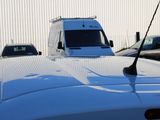 a white truck parked in a parking lot next to a building
