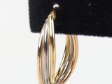 two tone gold hoop earrings on a black velvet ring holder