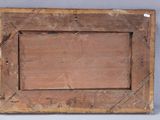an old wooden picture frame with a picture hanging on it