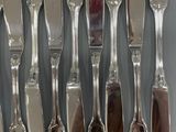a lot of silver spoons and forks on the table