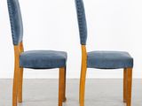 pair of blue upholstered chairs in the style of a pair of chairs
