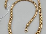 a gold chain with a clasp on a white background