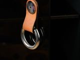leather keychain hanging on a glass shelf in a dark room