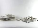 a lot of white plates and bowls on the table