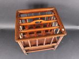 a wooden magazine rack with a magazine holder on top of it