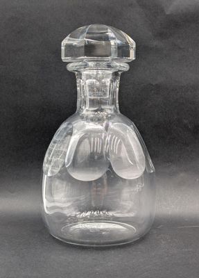 a clear glass bottle with a clear stopper on it