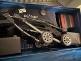 a baby stroller in the back of a blue truck