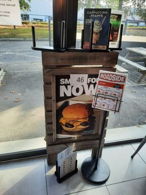 a newspaper dispenser with a sandwich on it