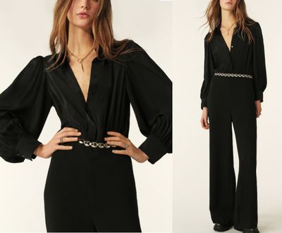 the woman is wearing a black jumpsuit with a belt