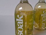 two bottles of soap sitting next to each other on a table