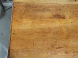 a small wooden table with a wooden top on the floor