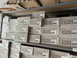 many boxes of electronic equipment on a shelf in a store