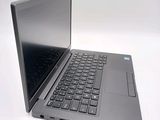 a laptop that is open on a white surface