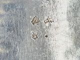 a close up of a piece of metal with some screws on it