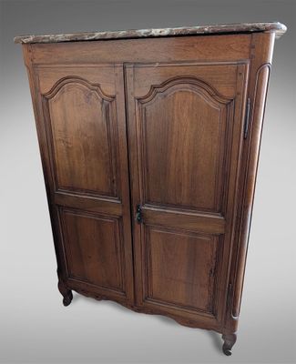 an old wooden armoire with marble top and two doors