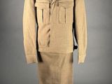an image of a mannequin dressed in a tan suit and hat