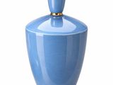 a blue vase with a gold lid on a white background