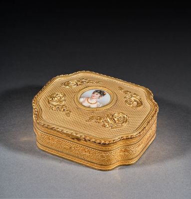 an antique gold box with a picture of a woman on it