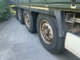 a large green truck that is parked on the side of the road