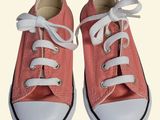 pair of pink converse shoes with white laces on a white background
