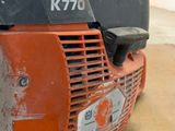 a close up of the front end of an orange and black mower