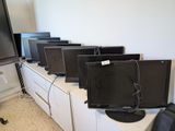 a lot of tvs that are sitting on top of the cabinets