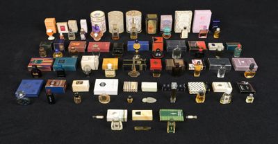 many different types of perfumes on a black surface