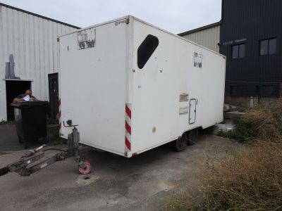 a white trailer that is parked in front of a building