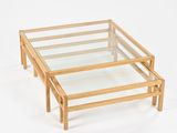 a glass and wood coffee table on a white background