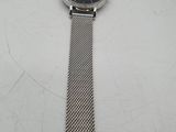 a close up of a watch on a table with a white background