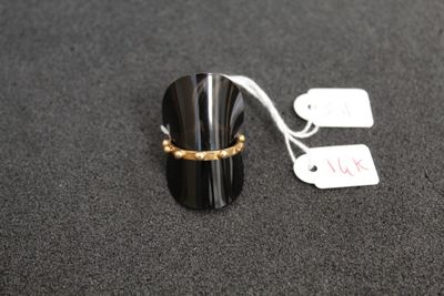 a ring that is sitting on top of a black object