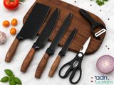 a cutting board with three knives and a cutting board with vegetables on it