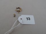a tag with a number on it next to a pair of earrings