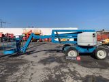 a close up of a blue scissor parked in a parking lot