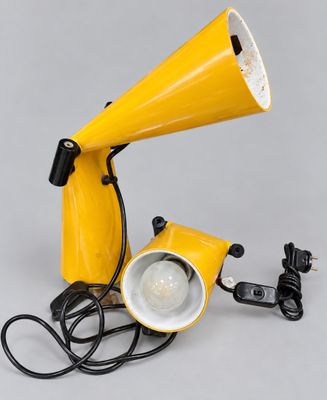 an image of a yellow lamp with a cord attached to it