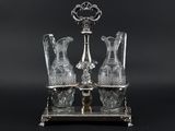 two crystal vases sitting on a silver stand