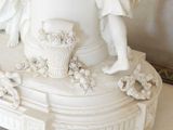 a statue of a woman holding a basket on top of a table