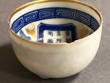 a small bowl with a blue and white design on it