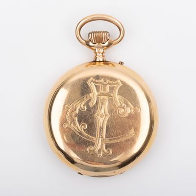 an antique gold pocket watch with a cross on the front