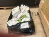 many bags of food sitting on the floor in the kitchen