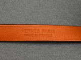 a close up of a leather belt on a gray surface
