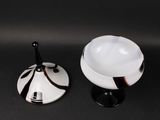 a white bowl and a black and white bowl on a black table
