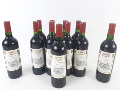 six bottles of wine are lined up in a row on a white surface