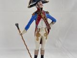 figurine of a man in a military uniform holding a cane