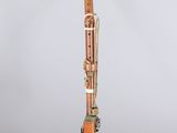 a wooden bassoon with an orange handle and a white background