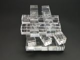 a stack of clear plastic boxes on a black surface