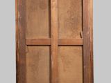 an old wooden cabinet with a glass door on a gray background