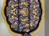 two decorative plates hanging on the wall next to each other