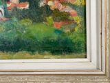 a painting of flowers in a white frame on the wall